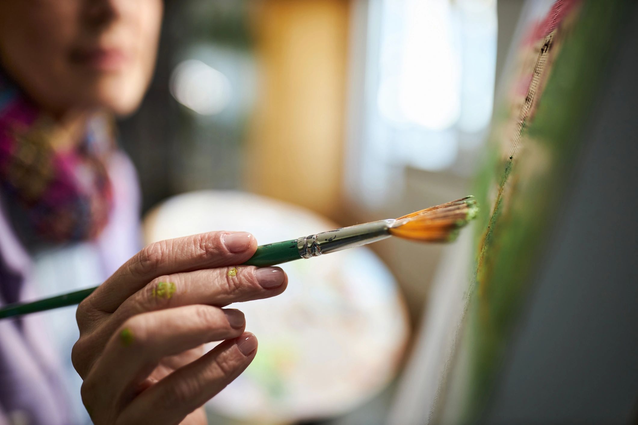 Close-up of a woman painting in a studio