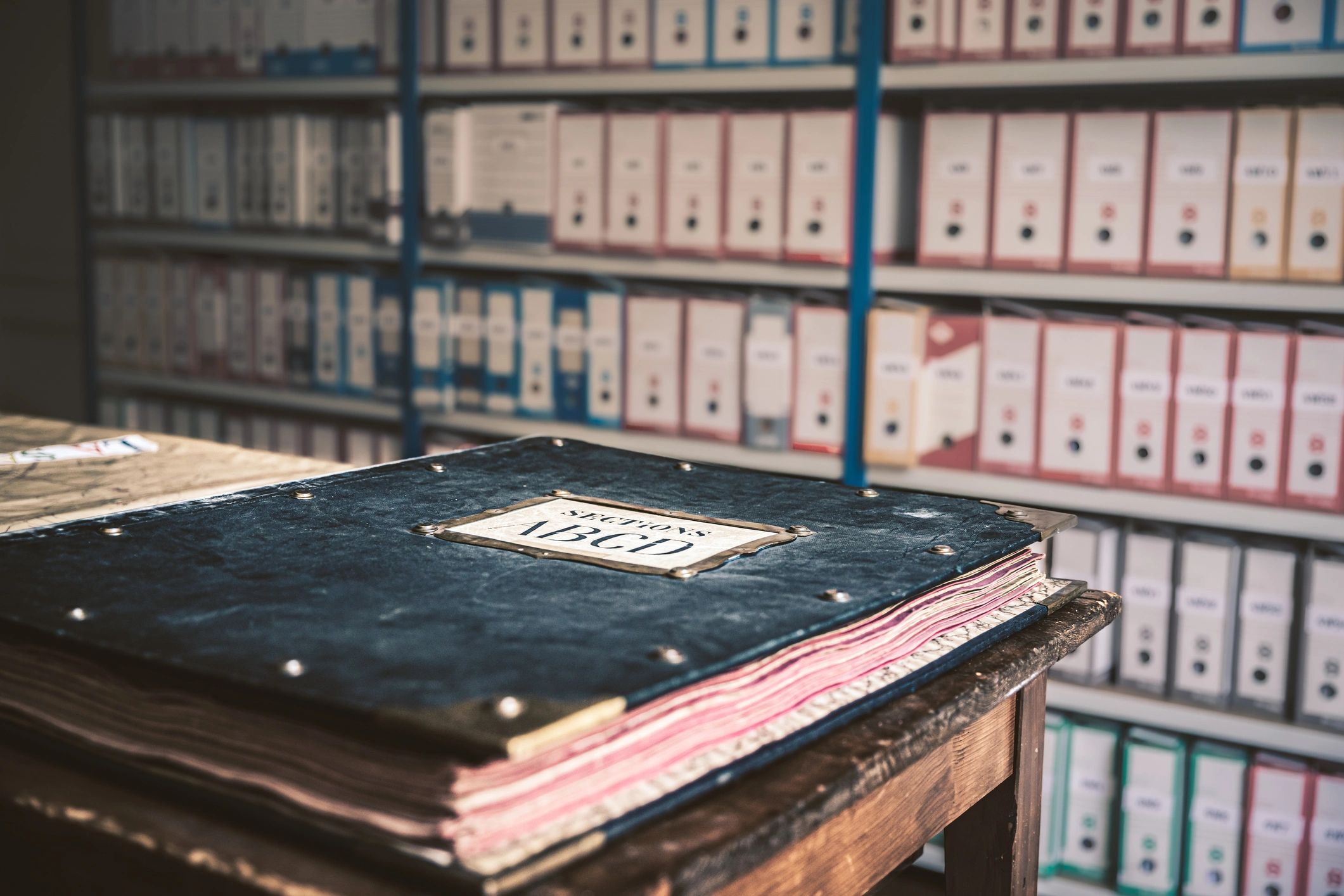 Archival book on a table with labeled sections